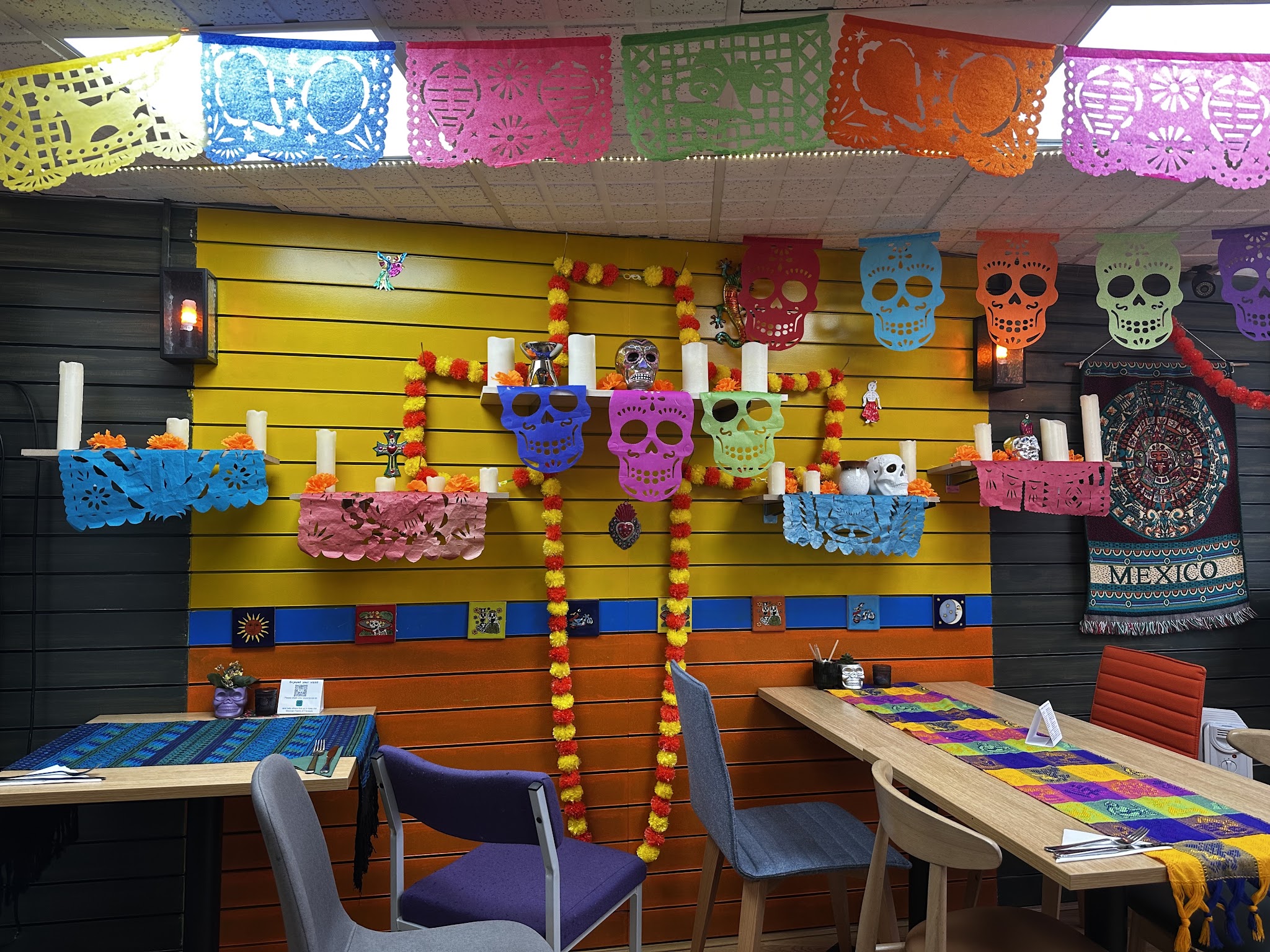 Hooleos dining room with colourful paper decorations and woven table runners