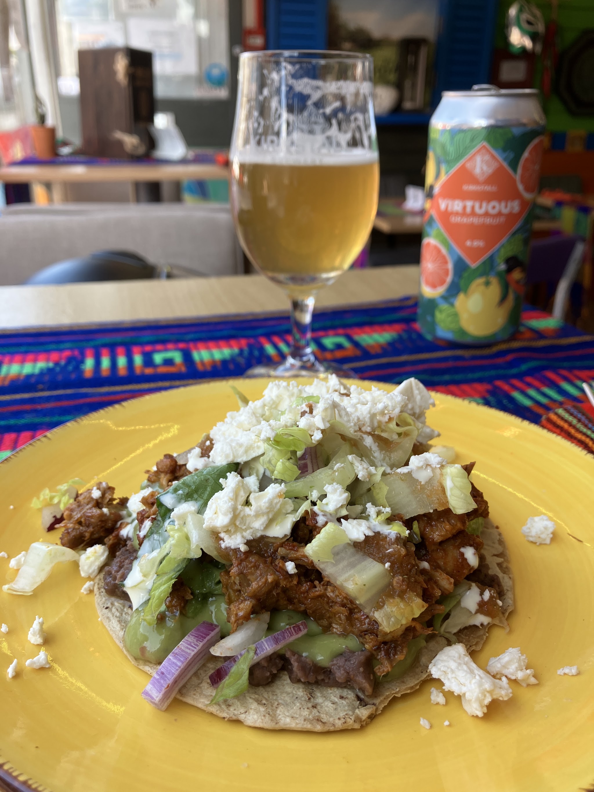A plated tortilla dish and a beer at Hooleos